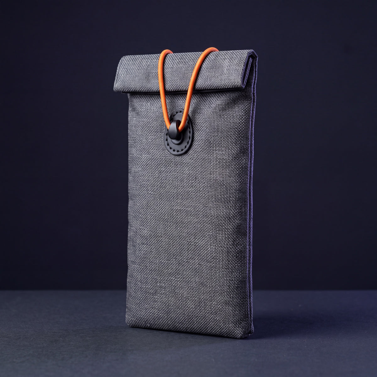 UnTrack Faraday phone sleeve, sealed with the orange cord